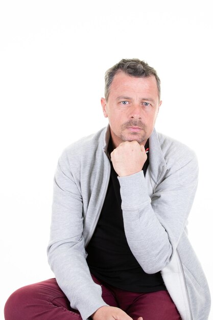 Portrait of happy handsome middle aged man smiling with hand on chin