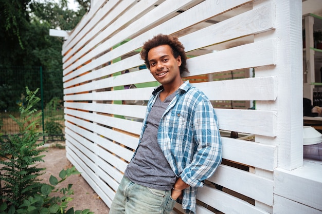 Portrait of happy handsome young man standing outdoors