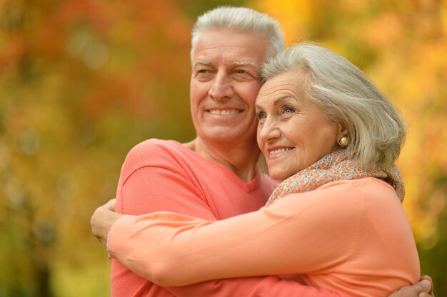 Portrait of a happy happy mature couple in autumn park