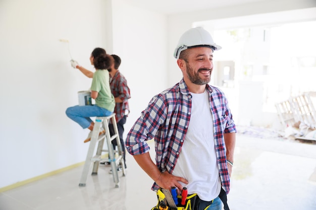 Portrait happy hispanic electrician man worker with professional builder team on construction site Maintenance service Repair and handyman concept