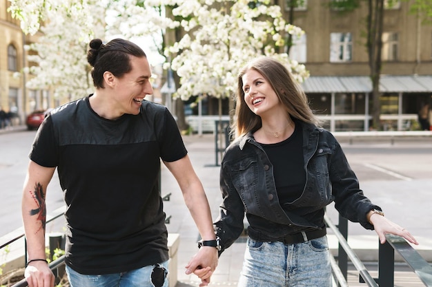 Portrait of happy laughing couple having fun during their date on a city street