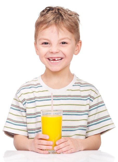 Portrait of happy little boy drinking refreshing orange juice Smiling child with glass of fresh lemonade