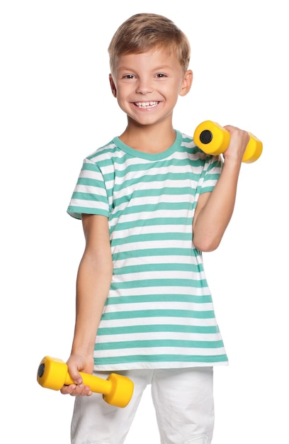 Portrait of happy little boy with dumbbells isolated on white background