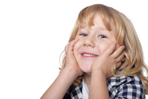 Portrait of happy little boy with long blond hair looking at  camera