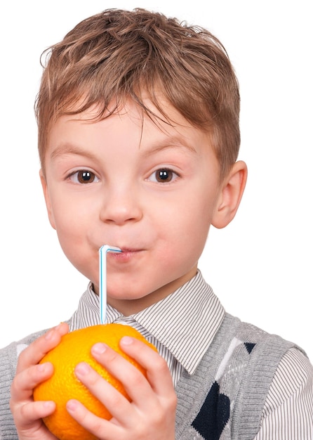 Portrait of happy little boy with orange juice isolated on white background