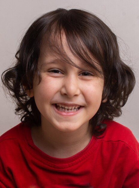 Photo portrait of happy little child holding miniature shopping cart