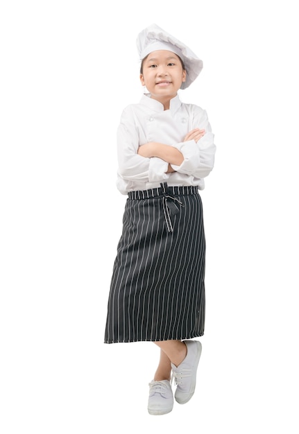 Portrait of Happy little girl in chef uniform is stand and smile isolated on white wall. Kid chef Concept