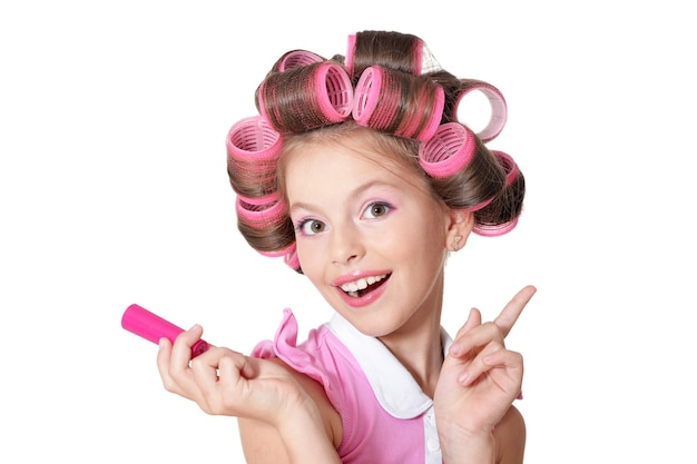 Portrait of happy Little pretty girl   in hair curlers in studio