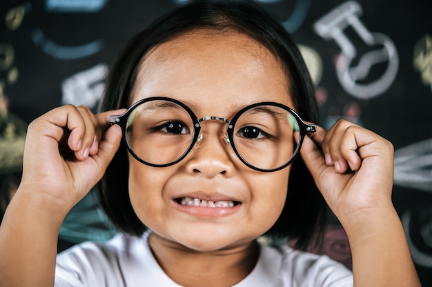 Portrait of happy little schoolchild wearing eyeglasses