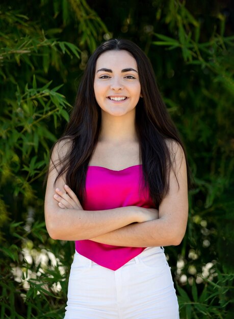 Portrait of a happy lovely and beautiful Spanish young woman in a park