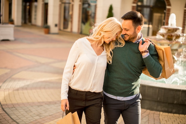 Portrait of happy loving couple with shopping bags