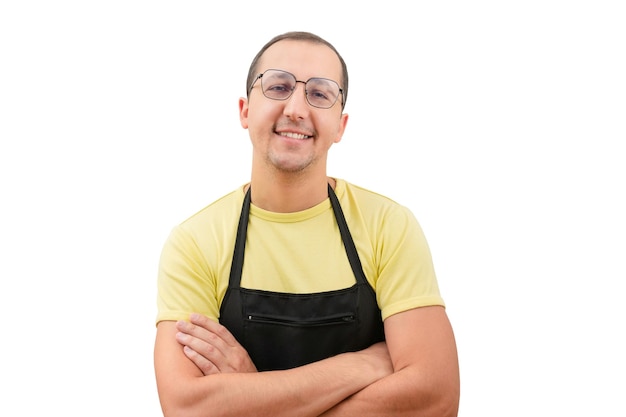 Portrait of a happy man in an apron looking at the camera on a white background