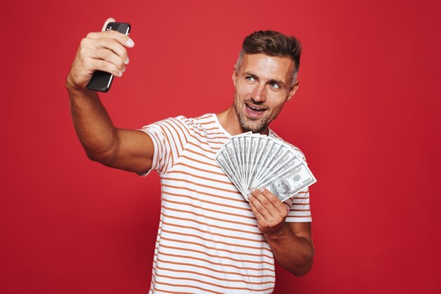 Portrait of a happy man standing on red