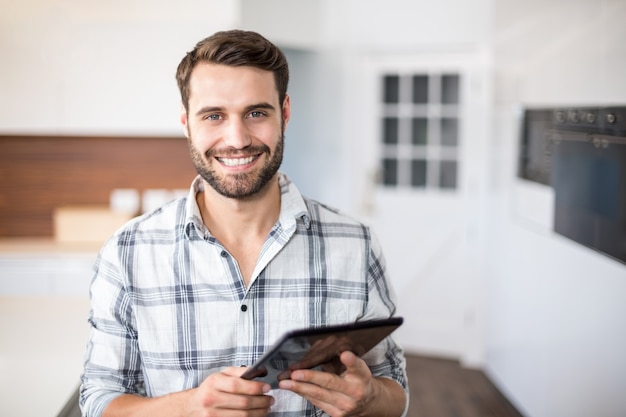 Portrait of happy man using digital tablet