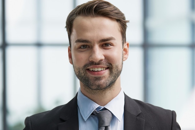 Portrait of a happy man wearing glasses and looking at the camera indoors