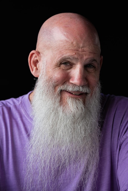 Portrait of happy man with long gray beard wearing purple tshirt closeup shot