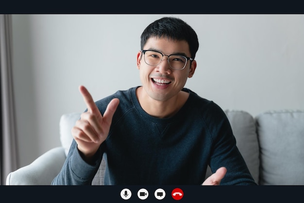 Portrait happy man working at home by video conference meeting talking and looking at camera