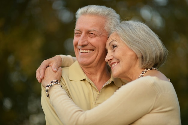 Portrait of a happy mature couple in autumn park