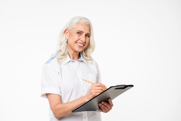 Portrait of a happy mature woman making notes