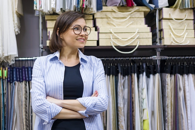 Portrait of happy mature woman owner