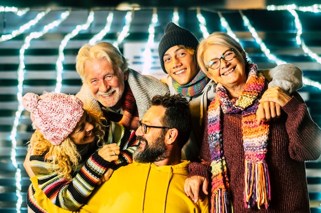 Portrait of happy mixed ages friends people celebrating outdoor new year eve