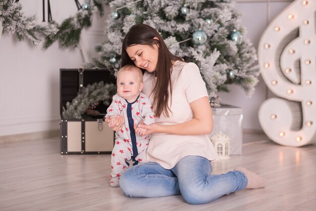 Portrait of a happy mom with Toddler Santa