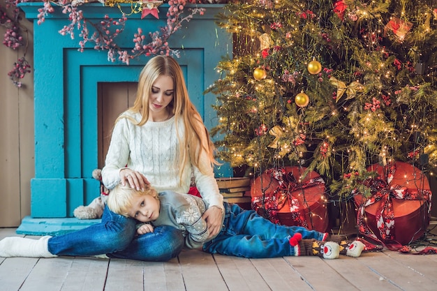 Portrait of happy mother and adorable boy, celebrating Christmas. Toddler with mom