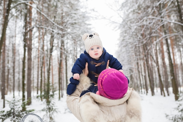 Portrait of happy mother and baby in winter park