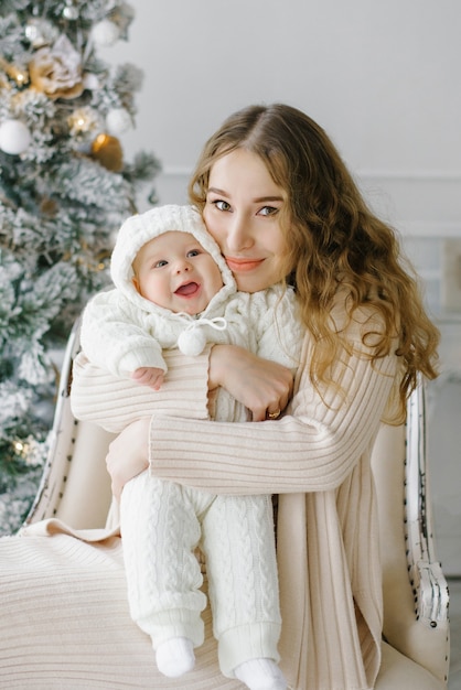 Portrait of a happy mother and a charming child celebrating Christmas