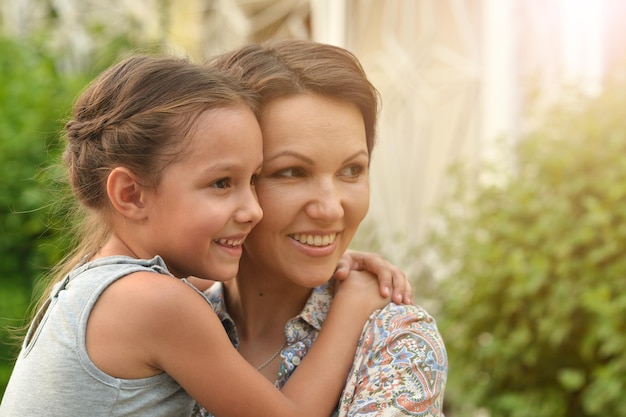 Portrait of happy mother and daughter outdoors