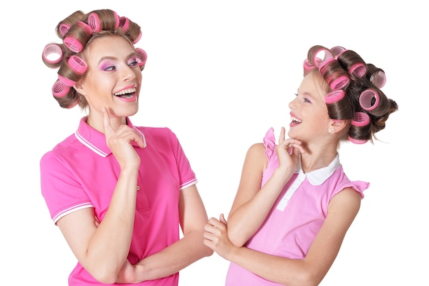 Portrait of happy  Mother and little daughter in hair curlers in studio