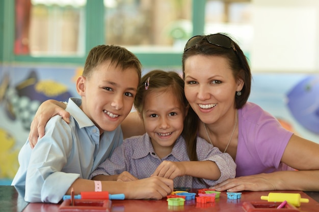 Portrait of a happy mother playing with her children