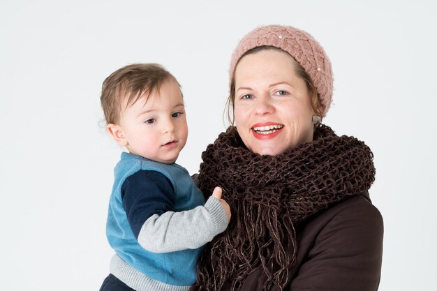 Portrait of happy mother and son against white background