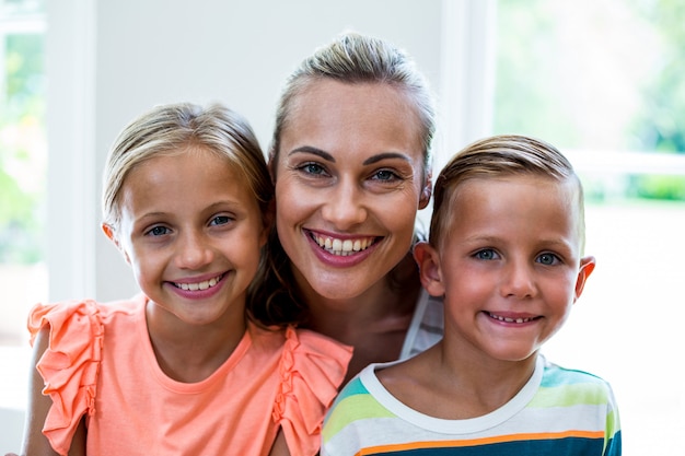 Portrait of happy mother with children at home