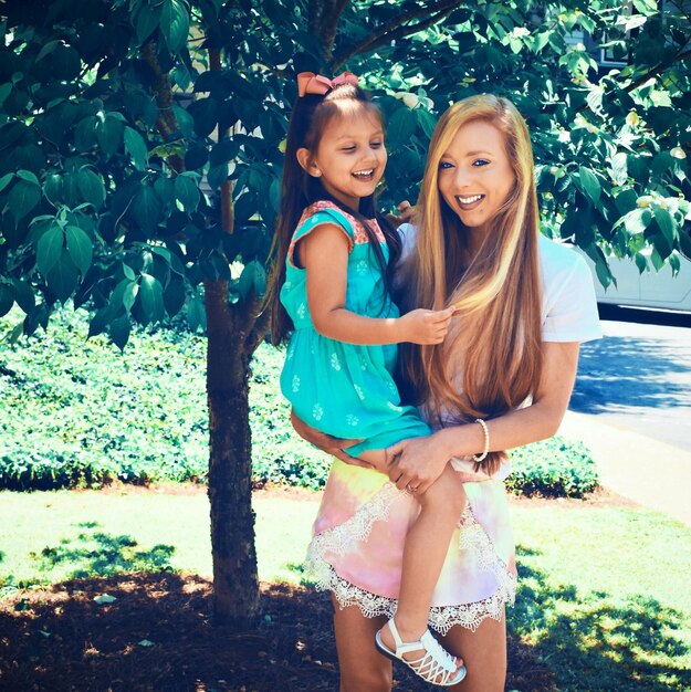 Photo portrait of happy mother with daughter standing on field