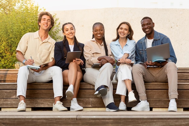 Portrait of happy multiethnic students posing at university campus