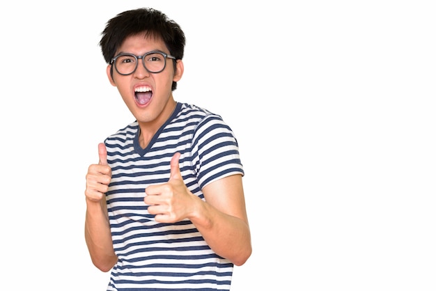 Portrait of happy nerd guy giving thumbs up isolated against white wall