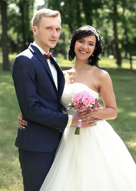 Portrait of happy newlyweds on the background of the Park