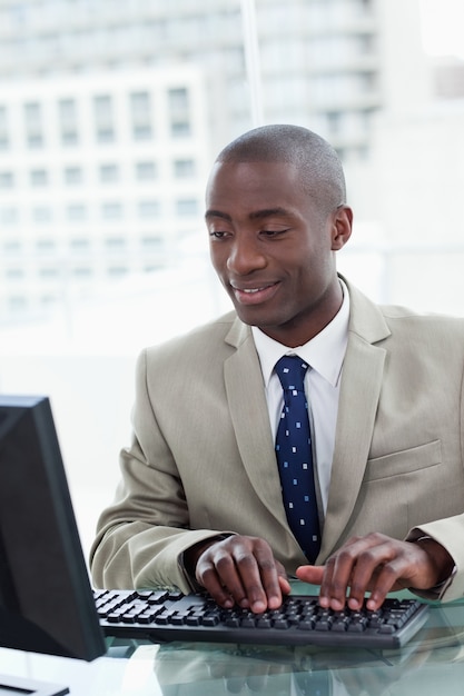 Portrait of a happy office worker using a computer