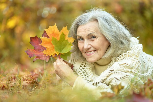 Portrait of a happy old woman posing at nature