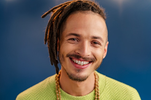 Portrait of a happy positive guy with dreadlocks