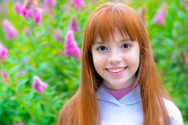 Portrait of a happy red haired freckles girl, outdoor, outside.