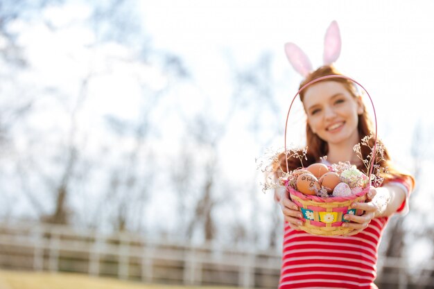 Portrait of a happy red head girl wearing bunny ears