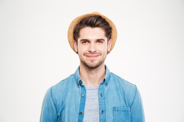 Portrait of happy relaxed young man in hat and blue shirt over white background