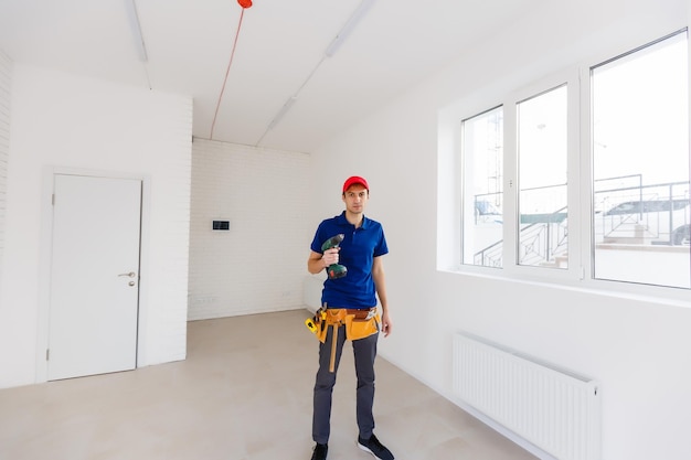 Portrait of happy repairman worker with tools