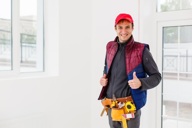 Portrait of happy repairman worker with tools