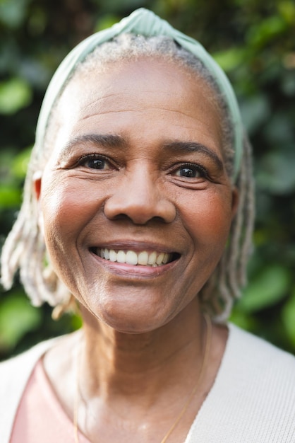 Portrait of happy senior african american woman standing in garden