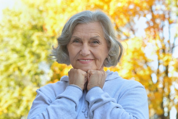 Foto ritratto di una bella donna anziana felice che posa all'aperto