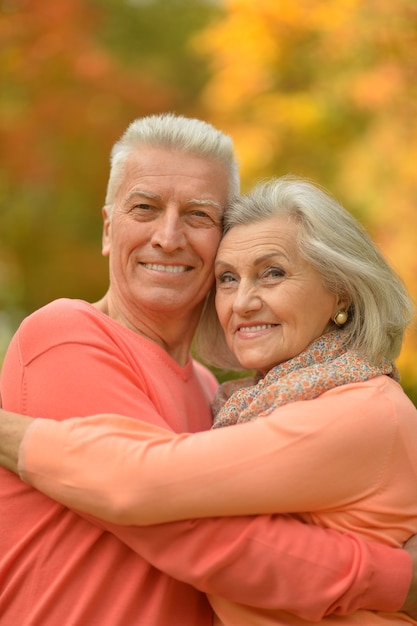 Portrait of a happy senior couple in autumn park