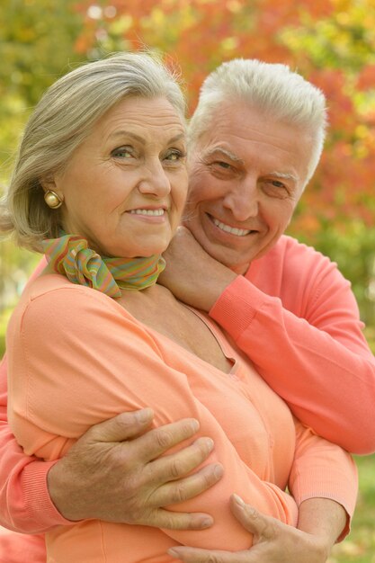 Portrait of a happy senior couple in autumn park